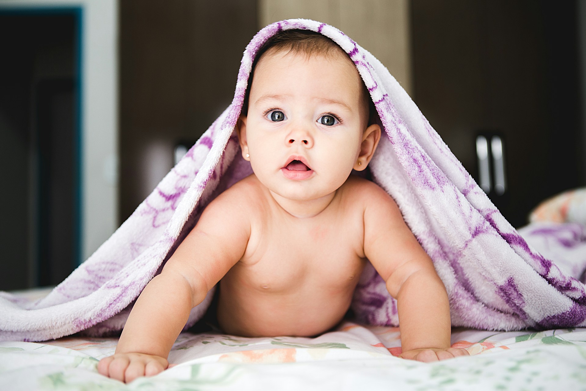 baby under the bedsheet cover